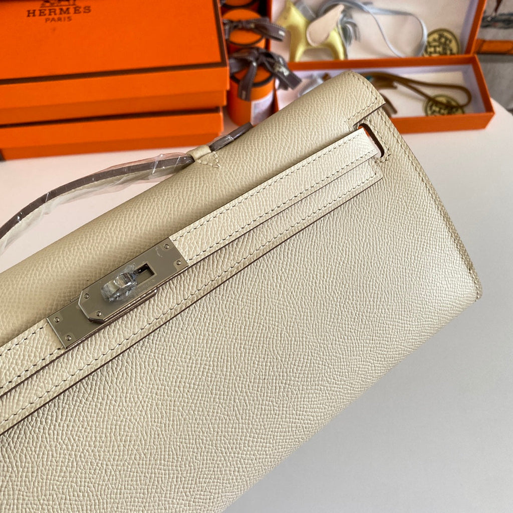 HERMES KELLY CUT 31 IN BEIGE CREAM CALFSKIN WITH SILVER HARDWARE