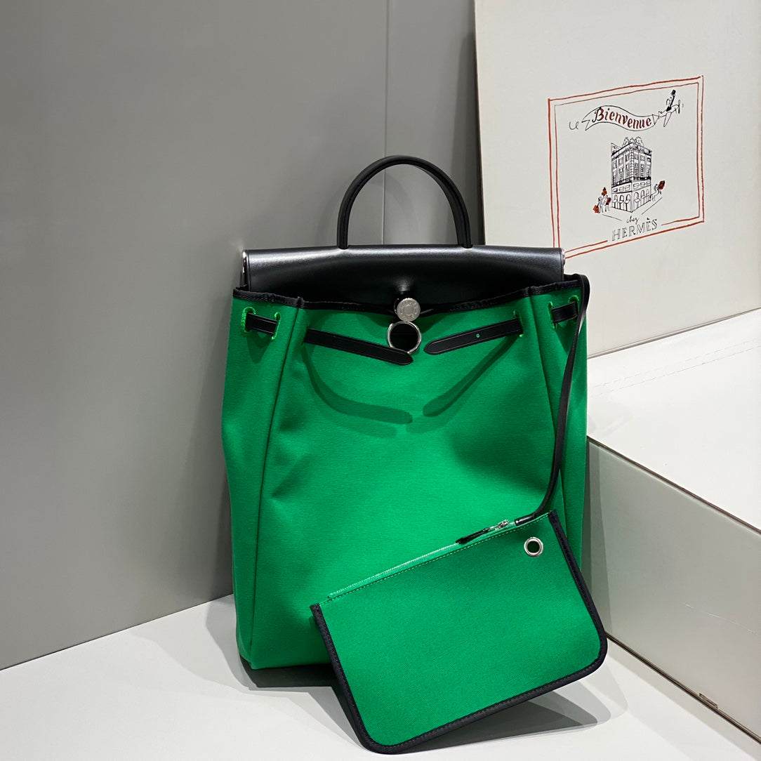 HERMES HERBAG A DOS ZIP RETOURNE BACKPACK 29 IN GREEN CANVAS AND BLACK CALFSKIN