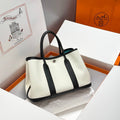 HERMES GARDEN PARTY 30CM IN WHITE TOILETS COTTON CANVAS AND BLACK CALFSKIN SKY BLUE CANVAS ON SIDE OTHER